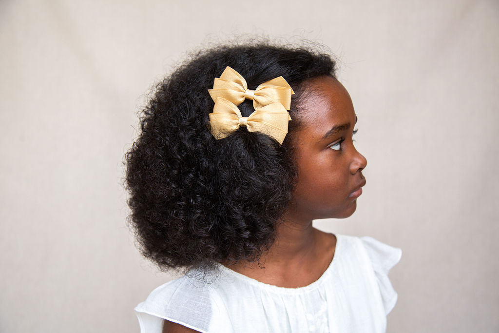 Medium Bow sparkly bow for girls in gold. Perfect hair accessory for Christmas!